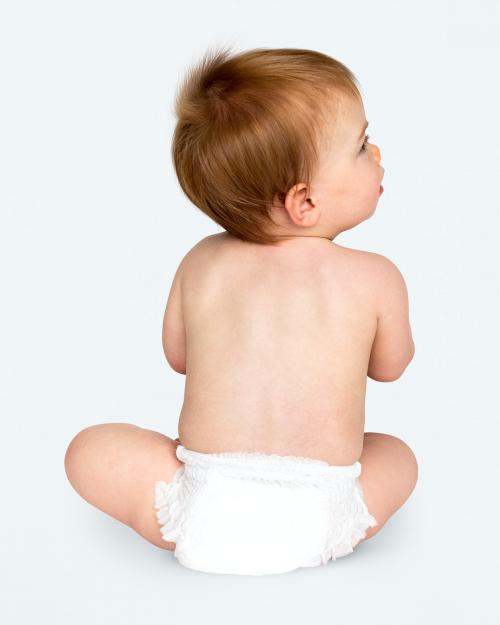 Baby in a diaper sitting on the floor - 546081