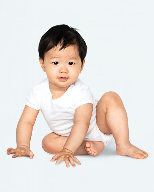 Baby sitting on the floor in a studio - 546148