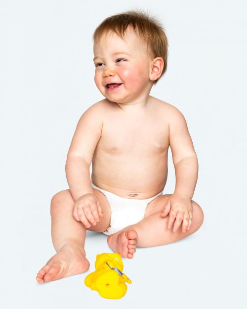 Baby in a diaper sitting on the floor - 546164