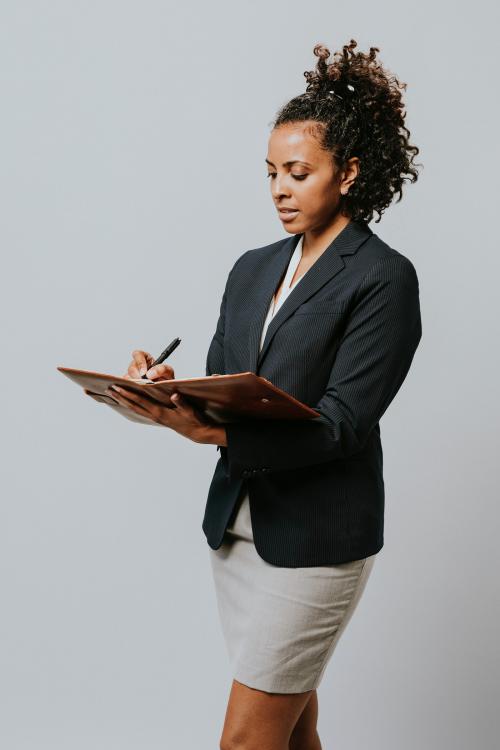 Businesswoman writing on her planner - 2020179