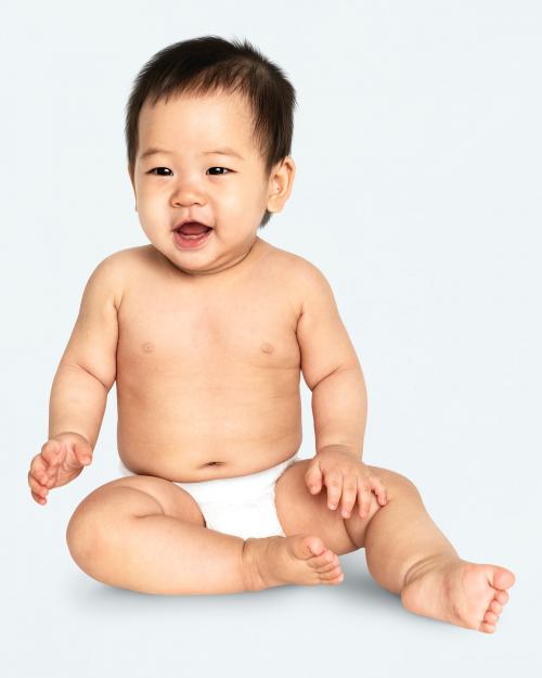 Baby in a diaper sitting on the floor - 546217