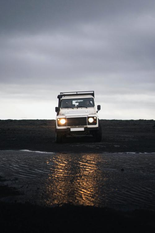 Land Rover crossing the puddle on the dirt road - 2042676