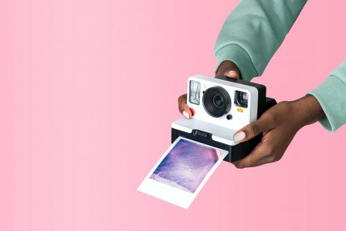 Hands holding an instant camera - 2054411