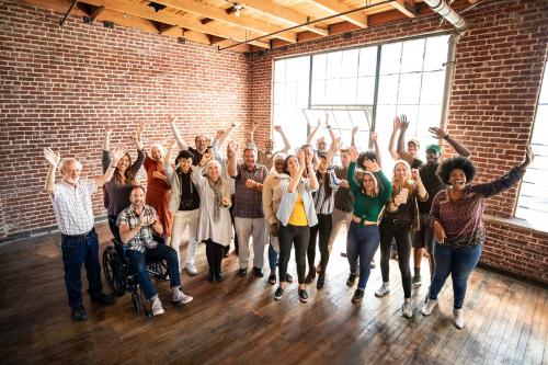 Group of diverse people standing in front of a brick wall - 2027144