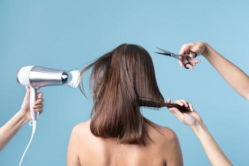 Woman getting a haircut and blow drying her hair - 2230357