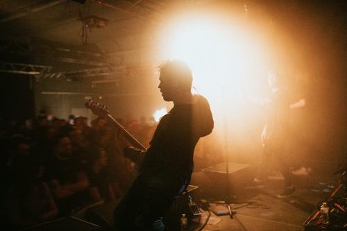 Guitarist playing an electric guitar in a concert - 2273413