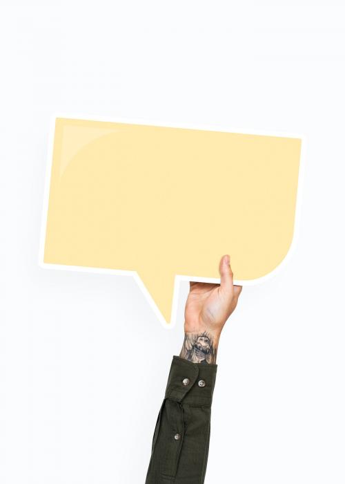 Hand holding a speech bubble cardboard prop - 526329