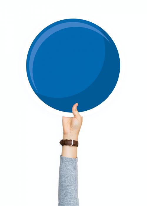 Hand holding a round blue cardboard prop - 526380