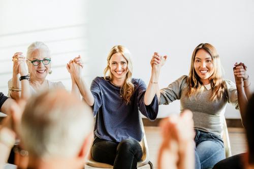 Group of diverse people holding hands up in the air - 2027462