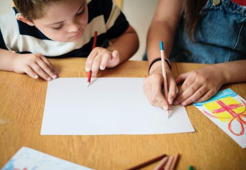 Sister and brother drawing at a table - 527161