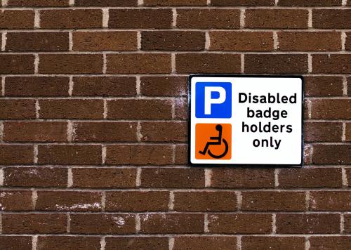 Disabled badge holders only sign on a brick wall - 531651