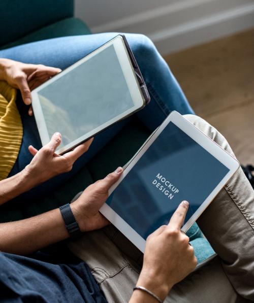 Man and woman using a tablet with a mockup screen - 534175