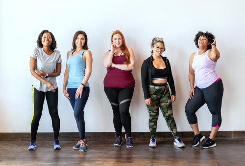 Group of sportive women standing by a brick wall - 2046905