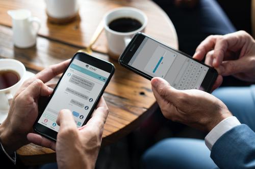 Business people using smartphones in a cafe - 534223