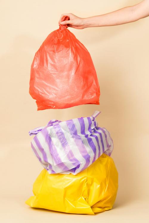 Colorful garbage bags isolated on yellow background - 2053006