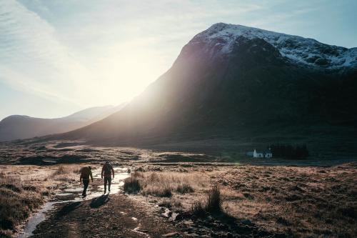 Hikers at Glen Coe valley in the Scottish Highlands - 2097836