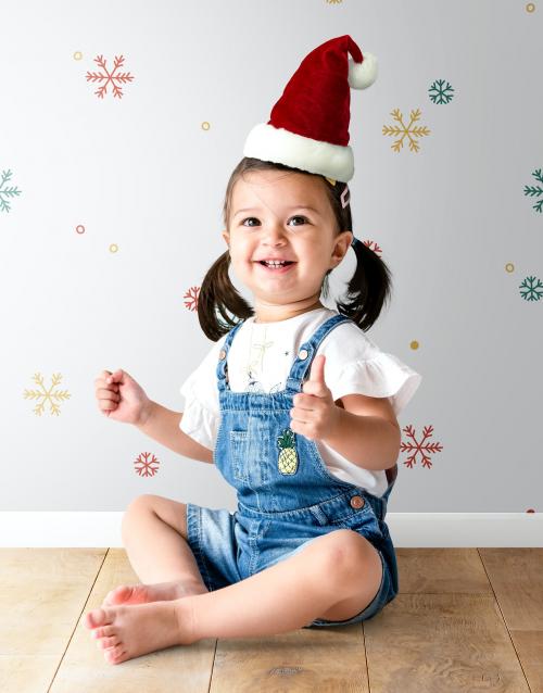 Cheerful little girl wearing a Christmas hat - 536039