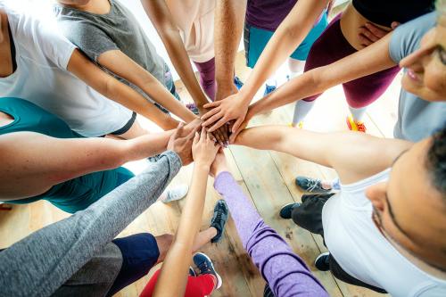 Group of diverse people stacking hands in the middle - 2194529