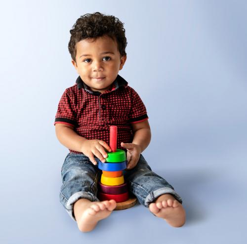 Happy boy with a stack of colorful discs - 536053