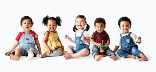 Cute diverse toddlers sitting together on the floor - 536060