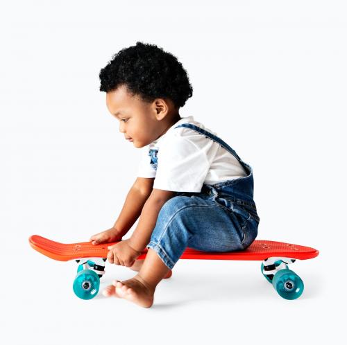 Cute little boy sitting on a skateboard - 536061