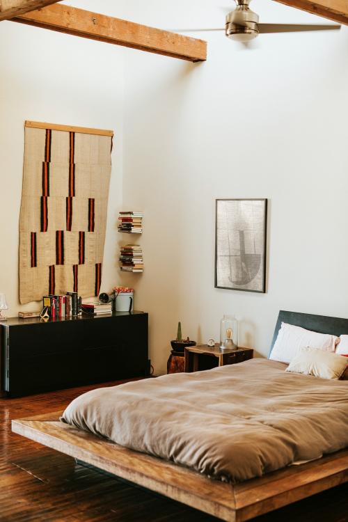 Industrial bedroom with dark wooden floors - 2204696