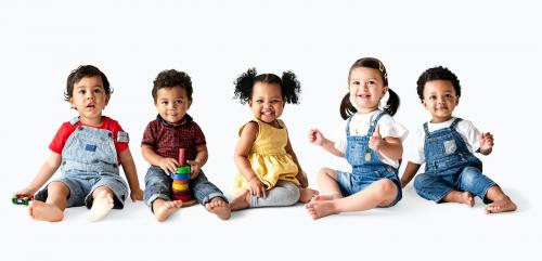 Cute diverse toddlers sitting together on the floor - 536064