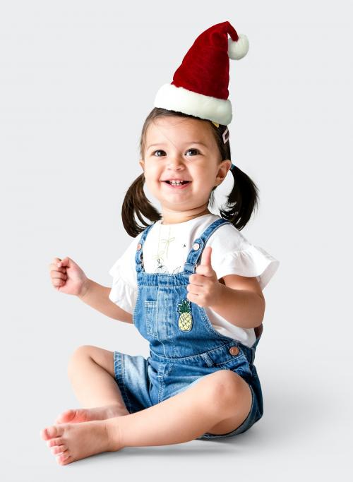 Cheerful little girl wearing a Christmas hat - 536072