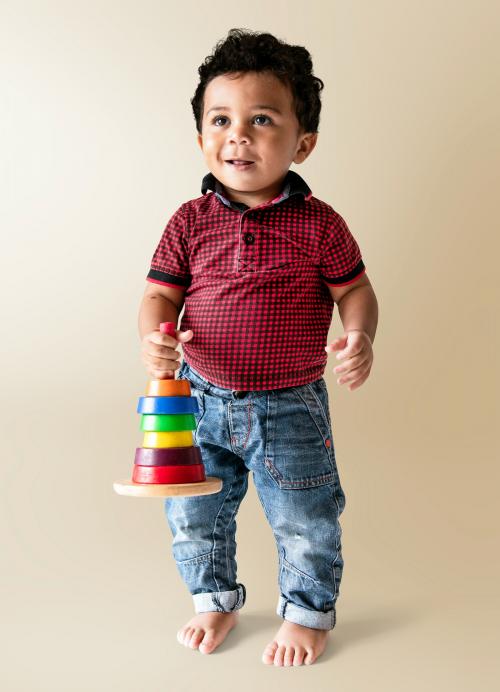 Happy boy holding a stack of colorful discs - 536073