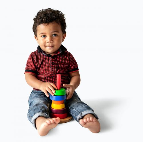 Happy boy with a stack of colorful discs - 536077