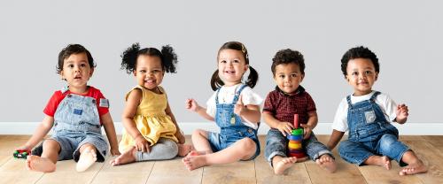 Cute diverse toddlers sitting together on the floor - 536081