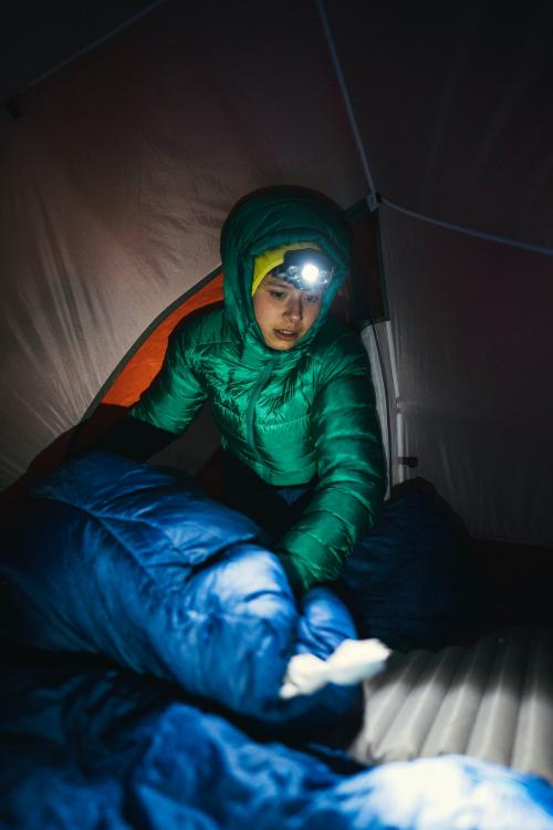 Preparing a sleeping bag in a tent for the cold night - 2221668