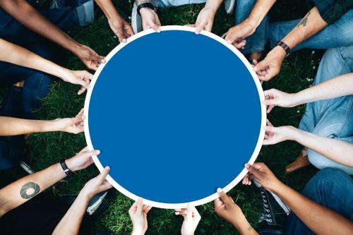 Group of people holding a round blue board - 537750