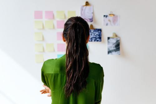 Creative woman with business plans on the wall - 2030436
