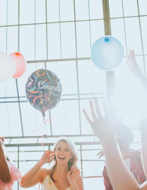 People playing with balloons at a party - 2097351