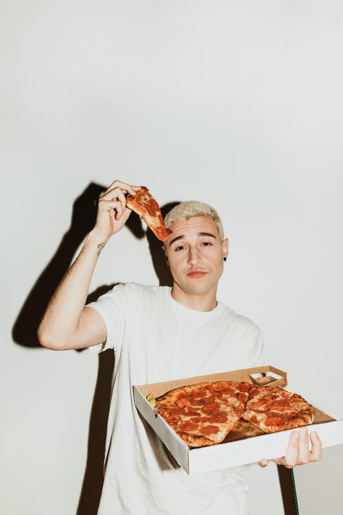 A man having a pepperoni pizza - 2097402