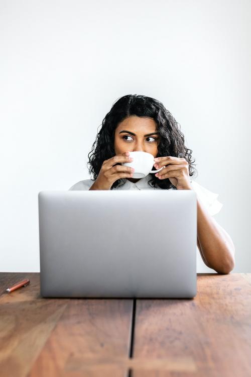 Black businesswoman drinking coffee - 2203519