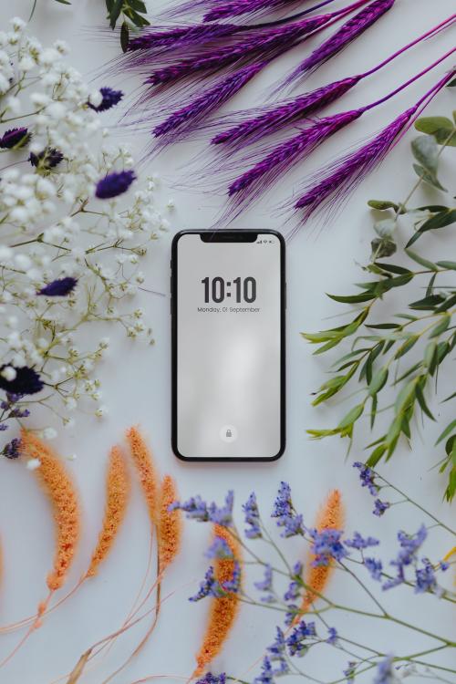 Phone mockup framed with a bunch of dried colorful flowers - 521277