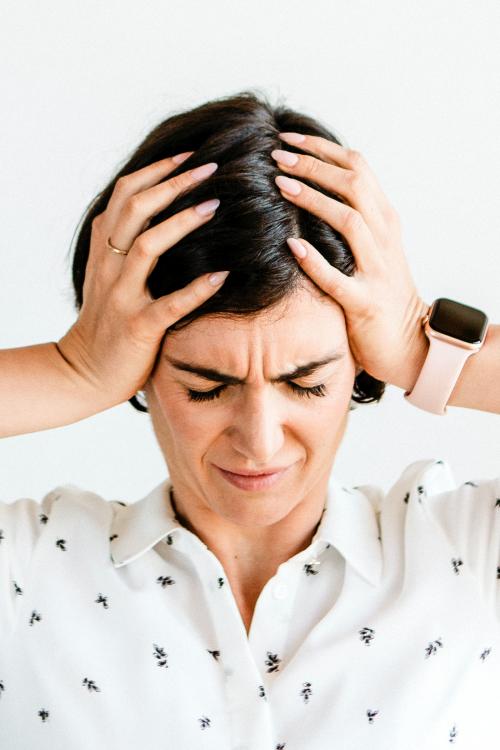 Stressed woman holding her forehead - 2030352