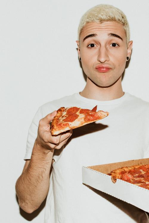 A man having a pepperoni pizza - 2097306