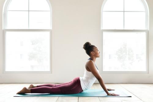 Black lady doing a Bhujangasana pose - 2194645