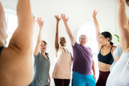 Group of people doing full body stretching in a class - 2194687