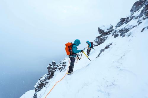 Mountaineers climbing a snowy Liathach Ridge in Scotland - 2221549