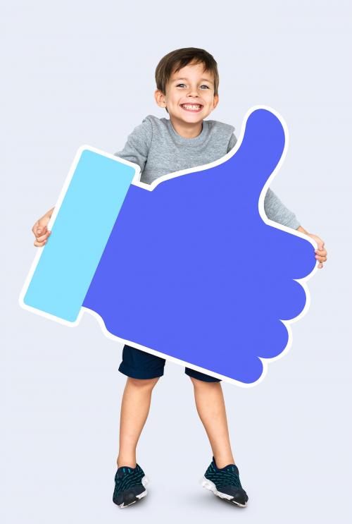 Happy boy holding a blue thumbs up icon - 504358