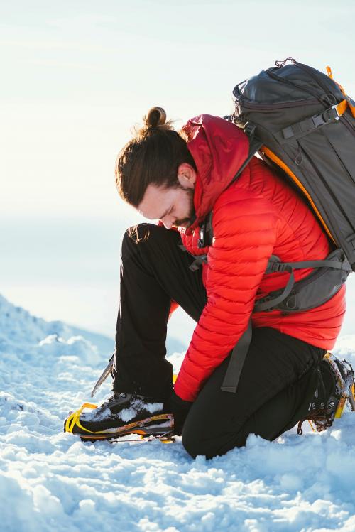 Man wearing crampons with his hiking shoes - 2097777