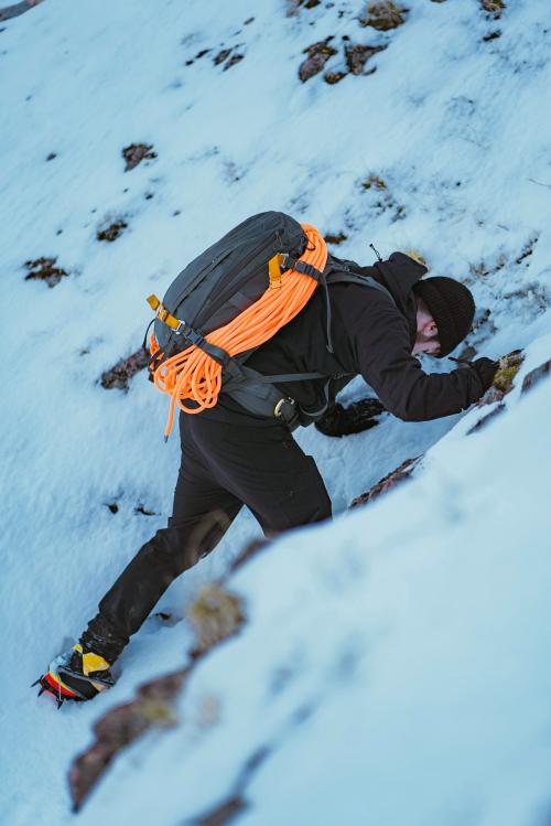 Mountaineer climbing a snow mountain - 2097918