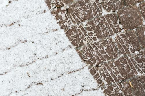 Skid marks on a a snowy cobblestone road background - 2255795