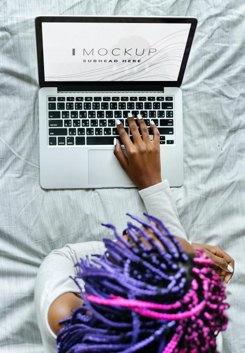 Woman using a laptop with a screen mockup - 502864