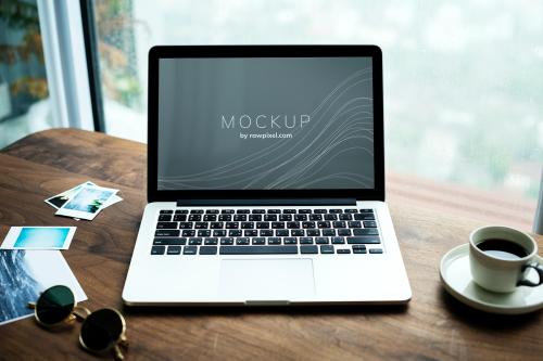 Laptop on a wooden table with a screen mockup - 502872