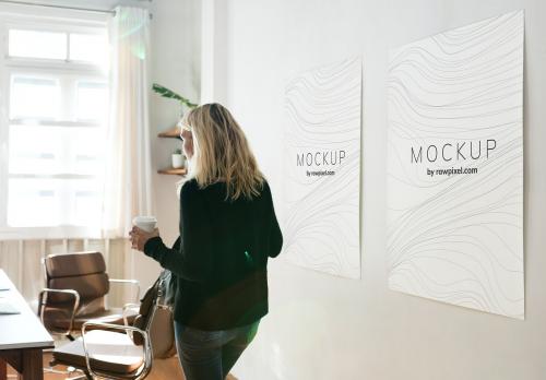 Woman in a working space with poster design mockups - 502876